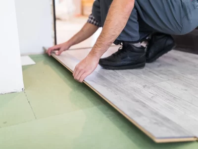 worker-processing-floor-with-laminated-flooring-boards_231208-4211